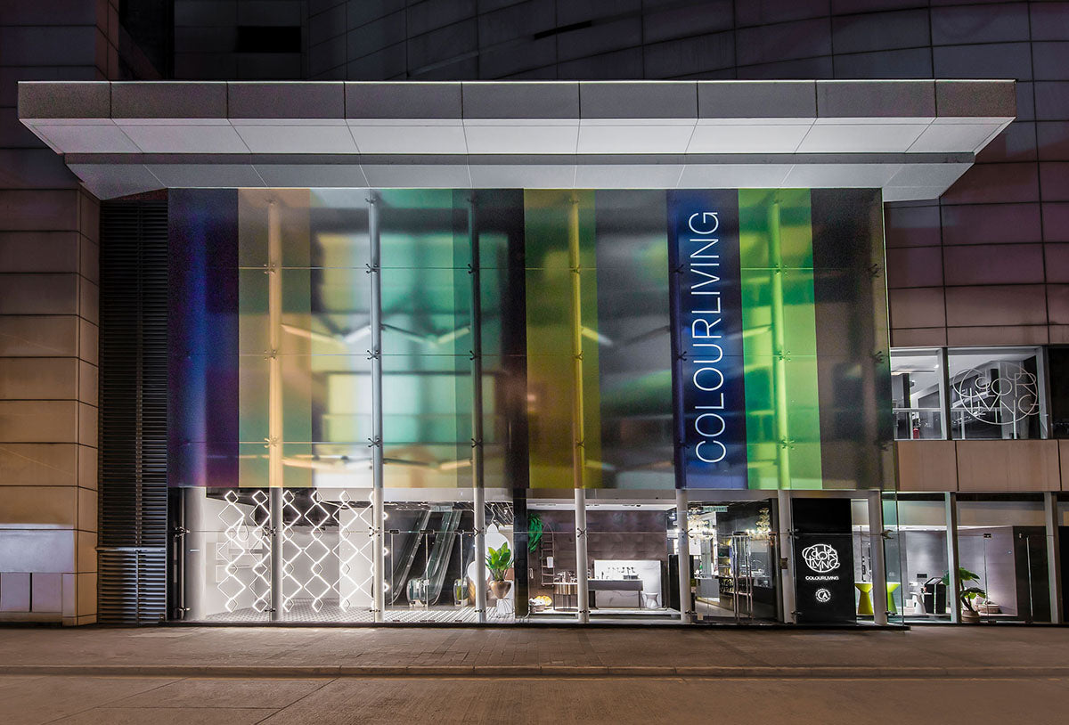 Modern building entrance with 'COLOURLIVING' branding on a colorful glass facade.