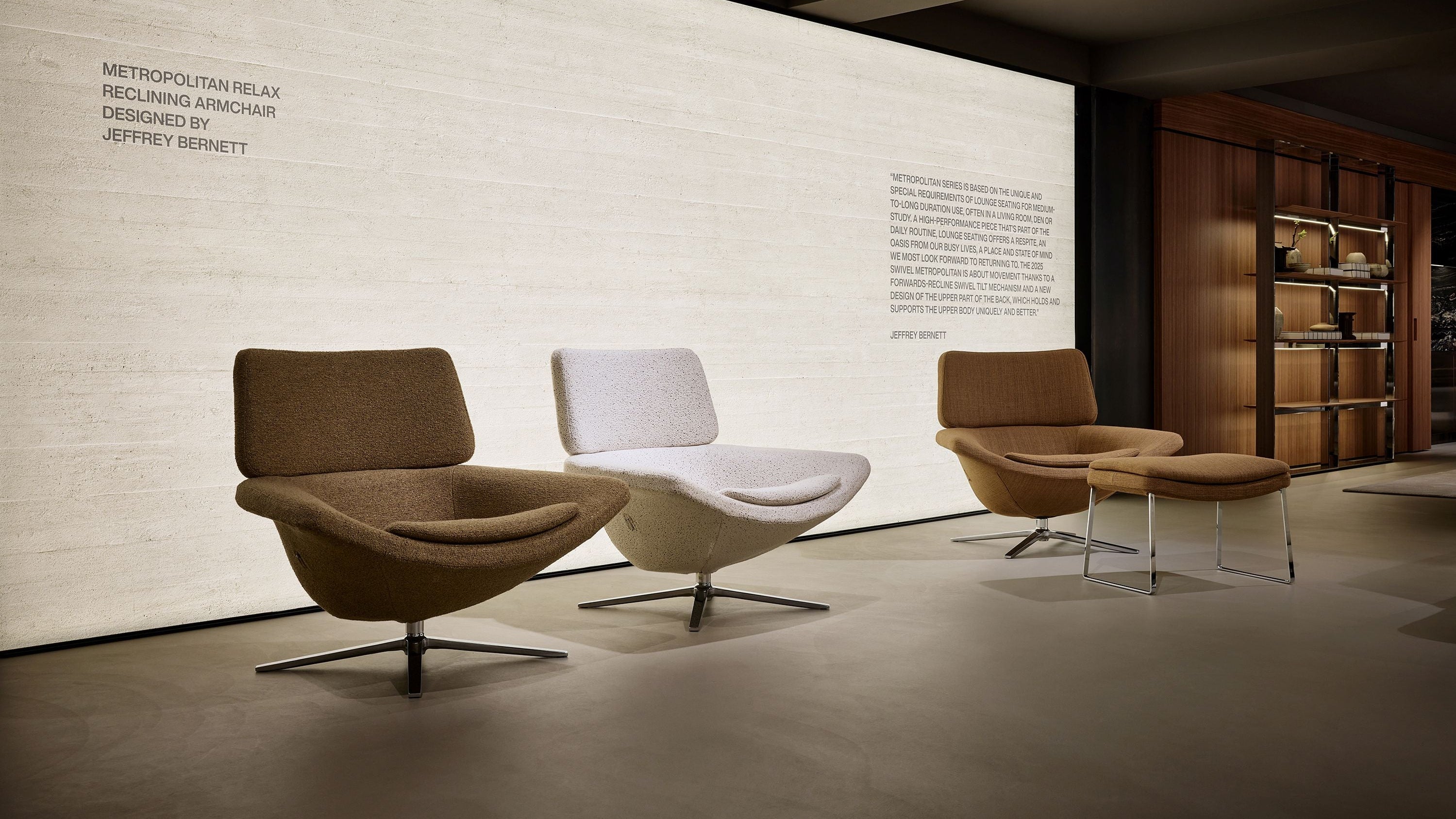 Modern furniture arrangement in a room with a large wall displaying text.