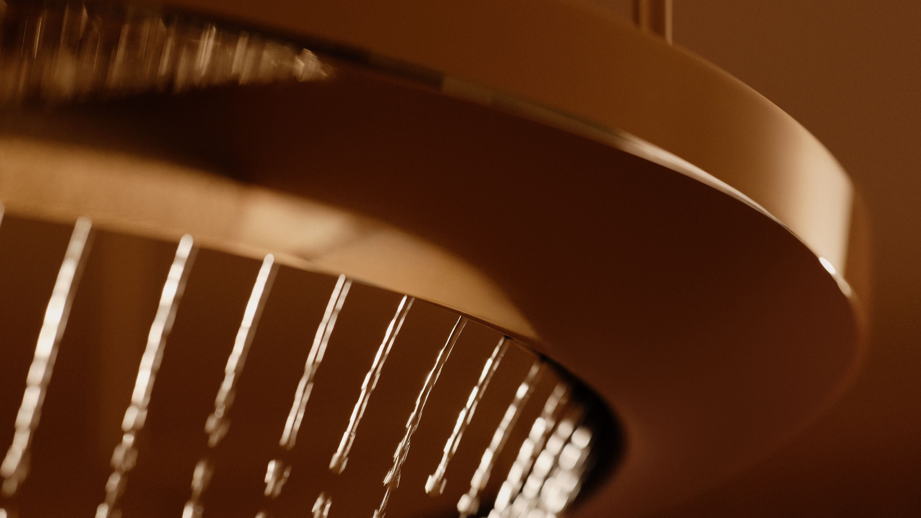 Close-up of a shower head with water droplets in sepia tone