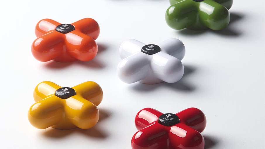 Colorful flower-shaped faucet handle on a white background