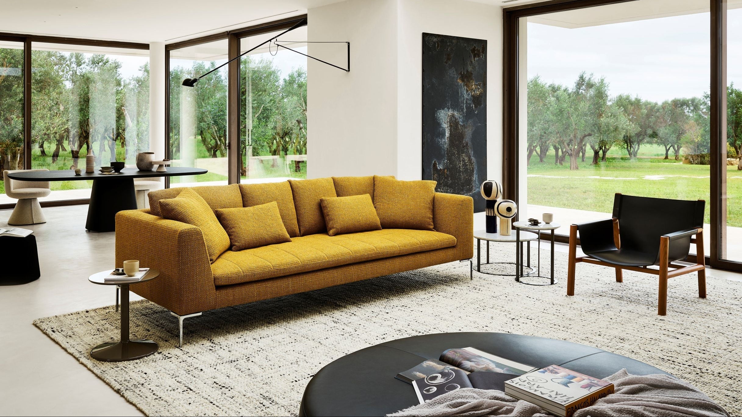 Modern living room with a yellow sofa and large windows.