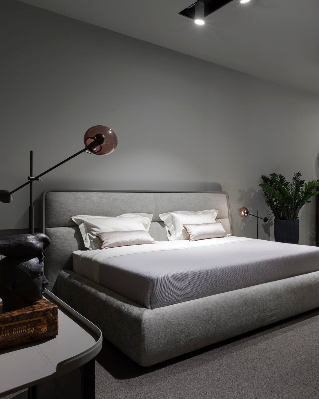 Modern bedroom with a gray bed and minimal decor