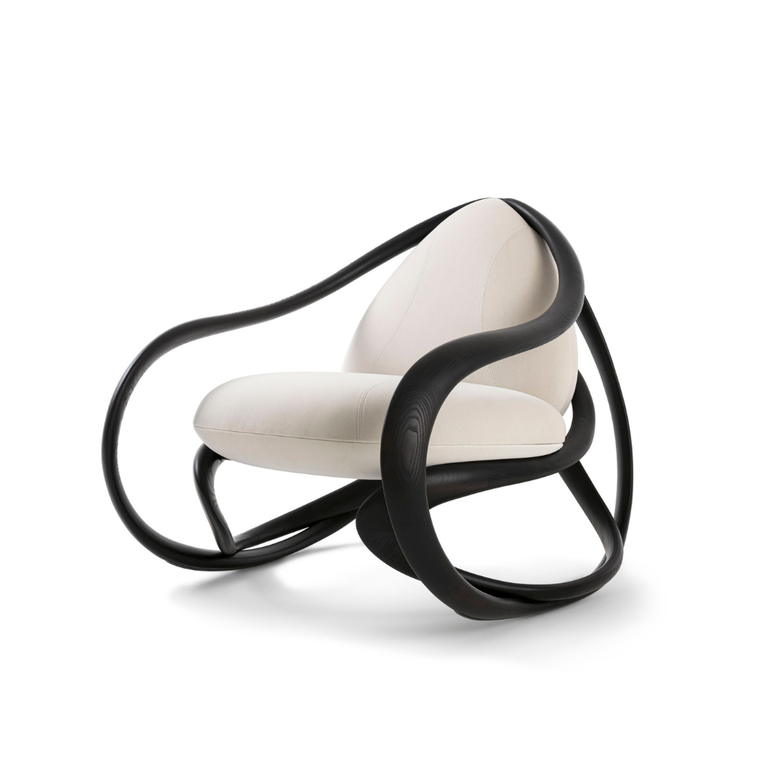 Modern chair with white seat and black curved frame on a white background